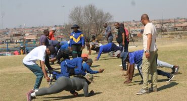 a group of people exercising on a soccer field