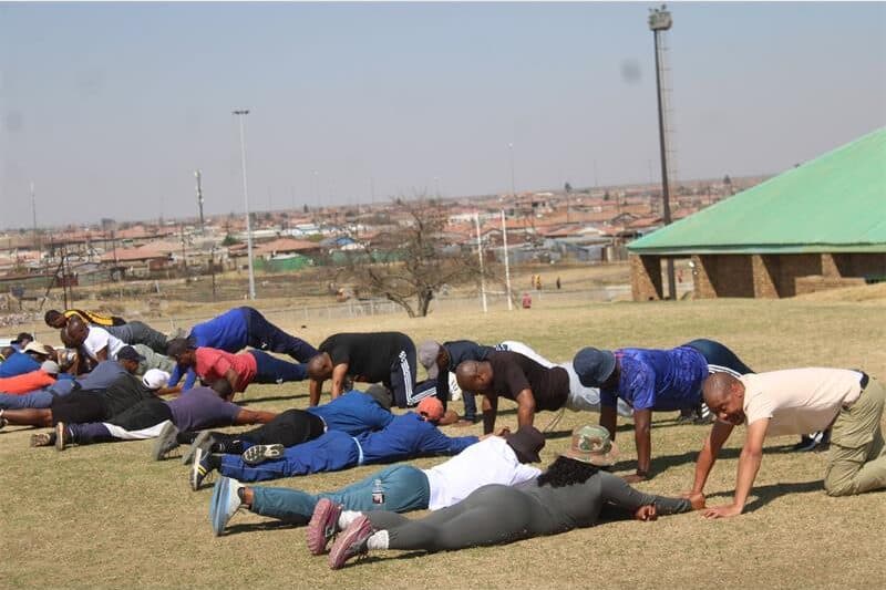 a group of people exercising on a soccer field