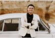 young boy is fessed in a white jacket and black shirt