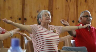 a woman opens her arms wide