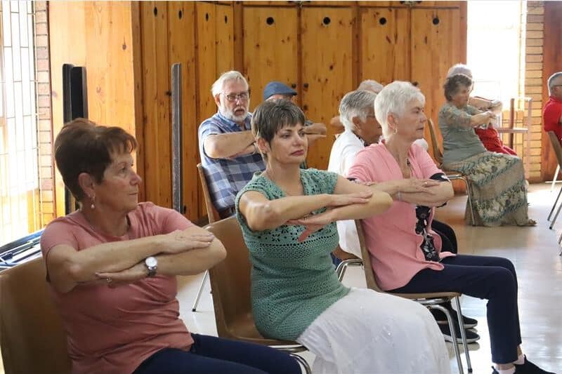 women in chairs cross their arms