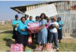 women hold up bags