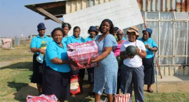 women hold up bags