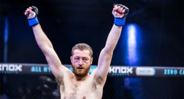 a fighter with his hand in the air as victory