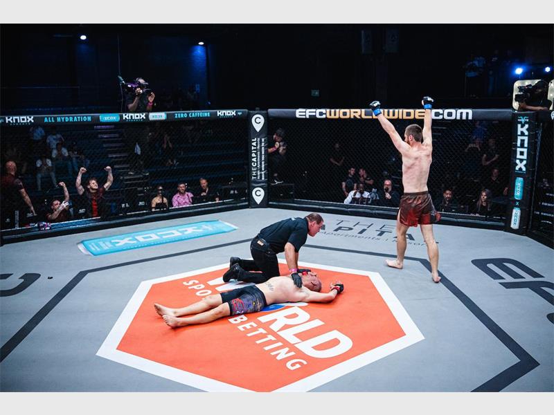 knocked out fighter is lying in the ring while the winner does a victory lap