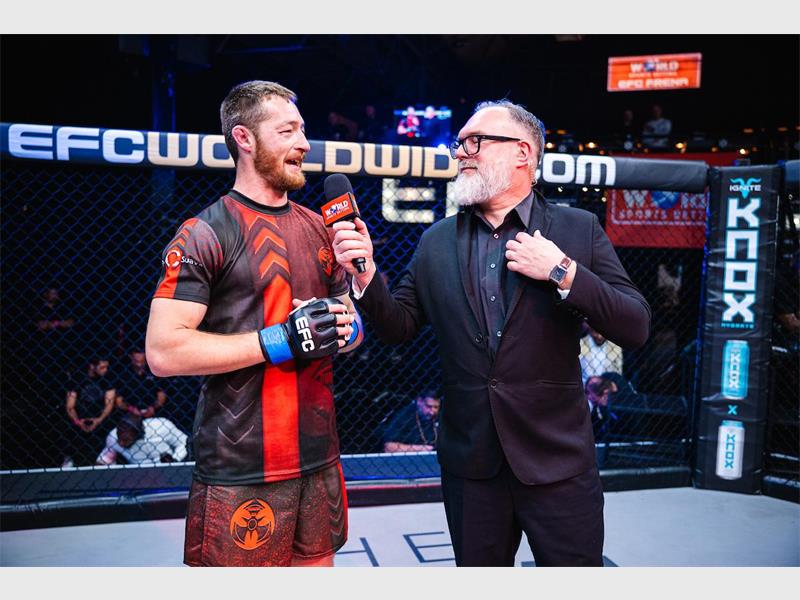 a winner speaks to the commentator in the ring