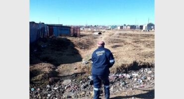 a person in an overall cleans up rubbish