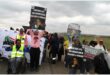 people holding up posters with anti gbv slogans