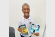 disabled man holds up two books