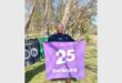 person with a purple 25 parkruns banner