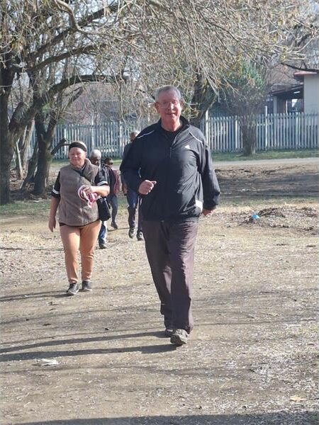 a man walking on a dirt road