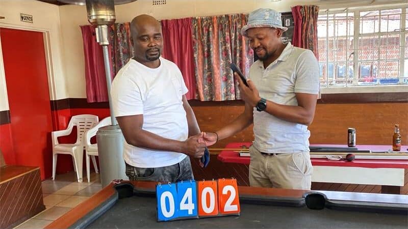 Two men at a pool table