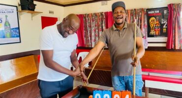 Two men at a pool table