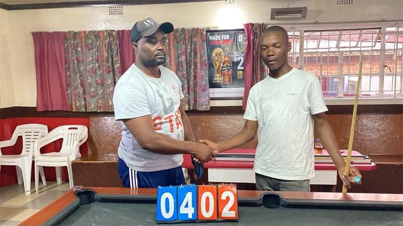 Two men at a pool table