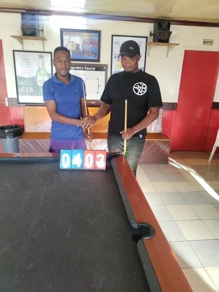 Two men at a pool table