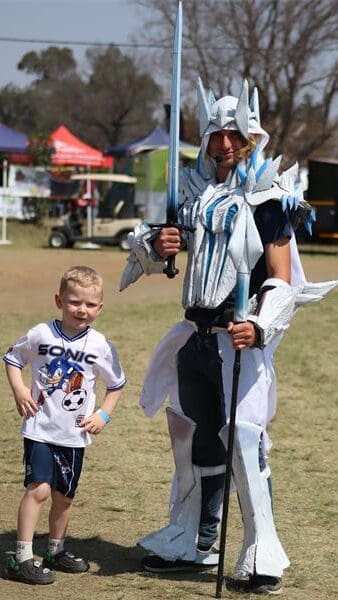 a little boy and a young man in cosplay