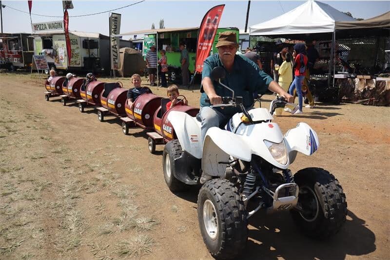 a quadbike pulling a train for kiddies
