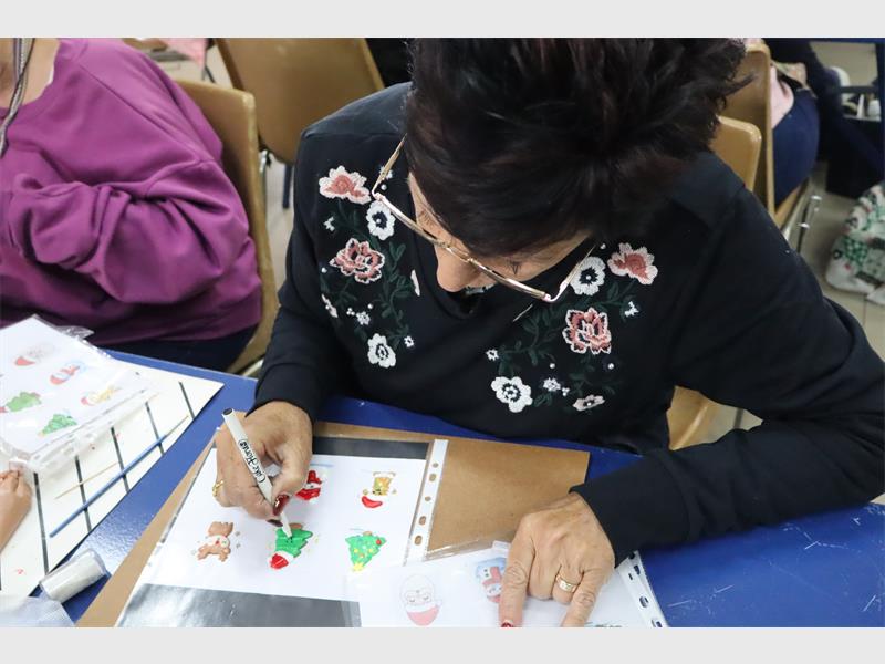 a woman makes christmas cake decorations