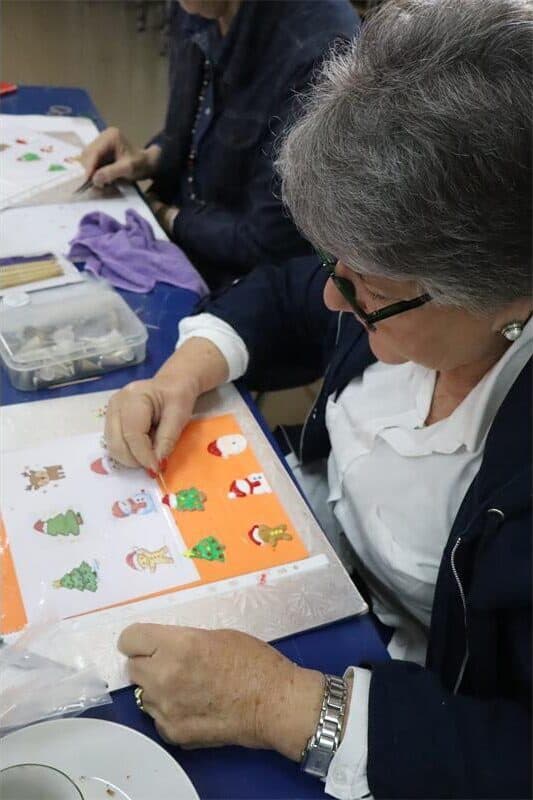a woman makes christmas cake decorations