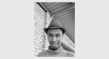 black and white photo of a man with a hat