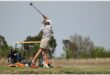 a woman tees off on the golf course