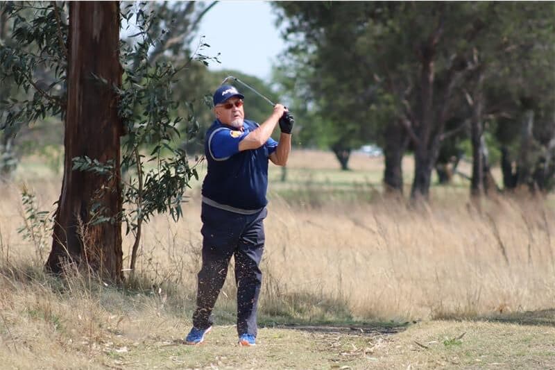 golfer hits ball out of the rough