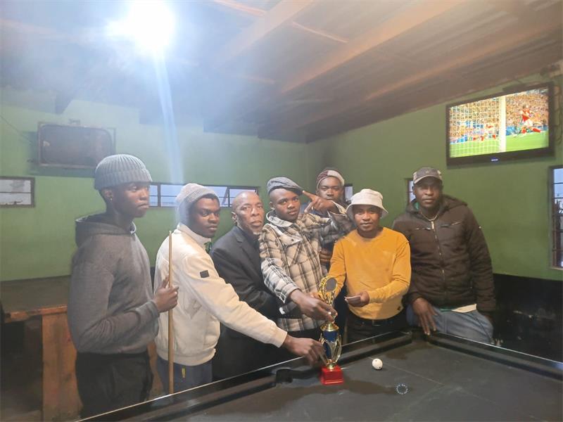 men at a pool table