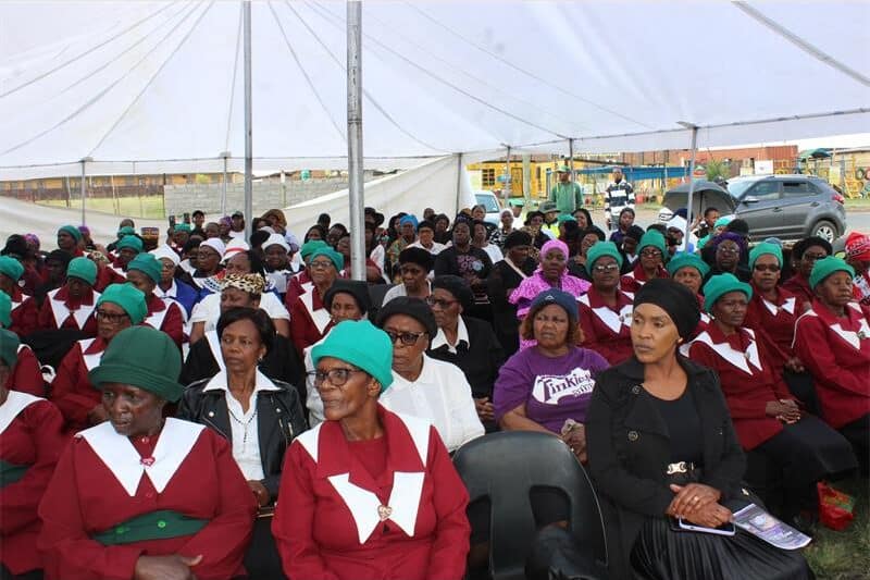 a crowd sits and listens to speeches