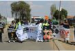 people march with banners in the road