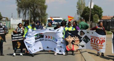 people march with banners in the road