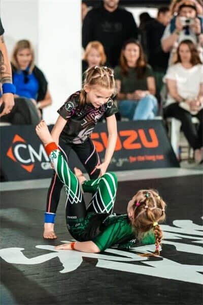 a girl pushes another to the ground
