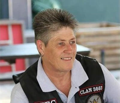 a woman with short hair and a biker's jacket