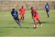 Two soccer teams compete for the ball