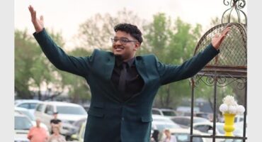 Young man with his hands in the air. He arrives at his matric farewell