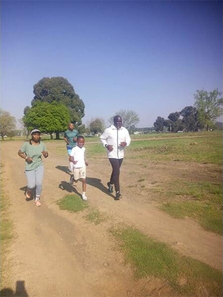 people running on a dirt road