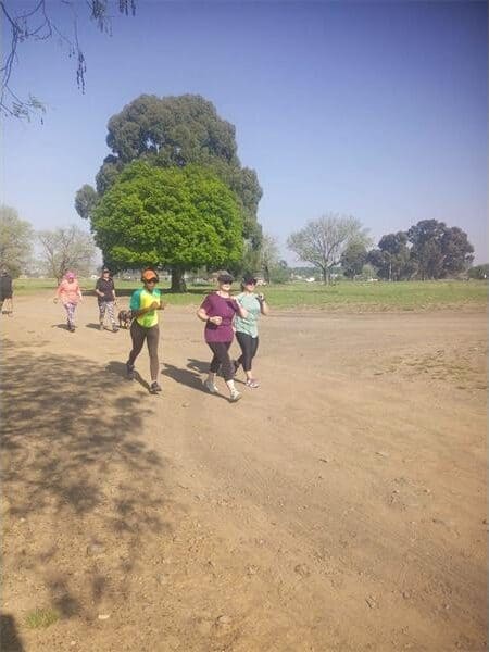 people running on a dirt road