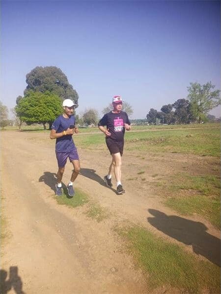 people running on a dirt road