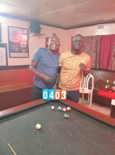two men at a pool table