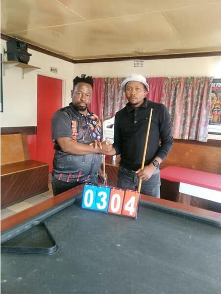 two men at a pool table