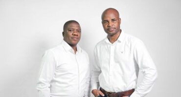 two men in jeans and white dress shirts