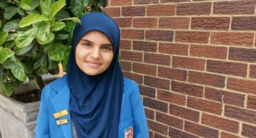 girl in blue school uniform with a head covering