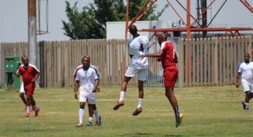red and white teams play soccer