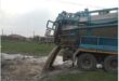 a honey sucker truck dumps its waste into a stream