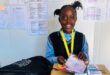 a school girl with lots of prizes and a medal