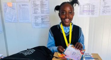 a school girl with lots of prizes and a medal