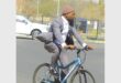 man in a suit on a bicycle