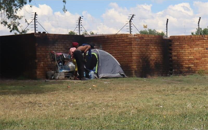 illegal structures against a wall in the cbd